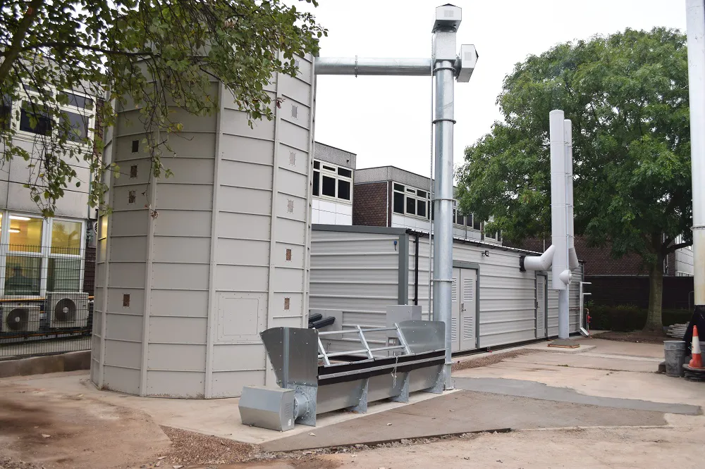 Biomass silo installation beside building